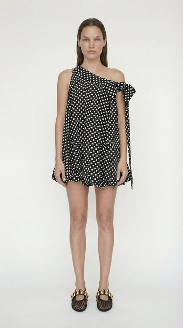 Front view of the black and white polka dot mini dress featuring a playful bubble hem and feminine bow straps, perfect for the coquette fashion trend.