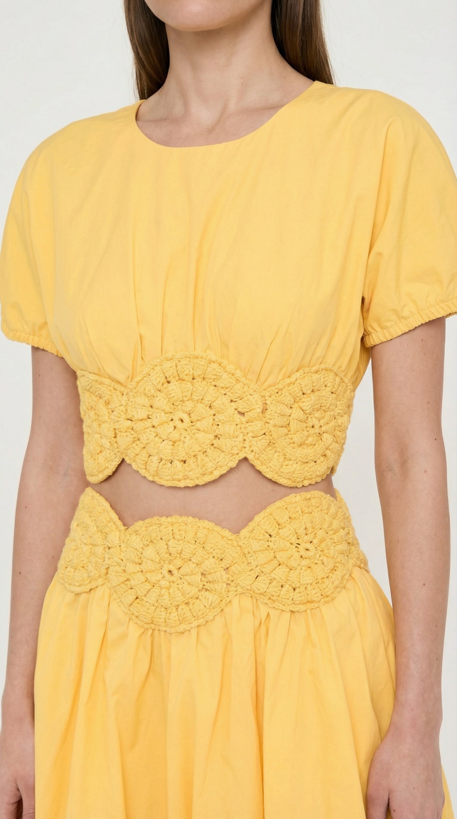 Close-up of the short puff sleeves with elastic cuffs on the Elexiay Amara cotton top, showcasing the crisp yellow poplin fabric texture and non machine made crochet applique.