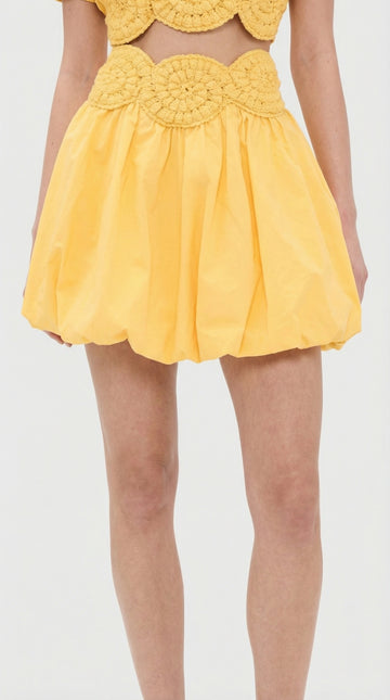 Model wearing the Elexiay Amara yellow crochet top paired with a matching skirt, styled for a summer resort look.
