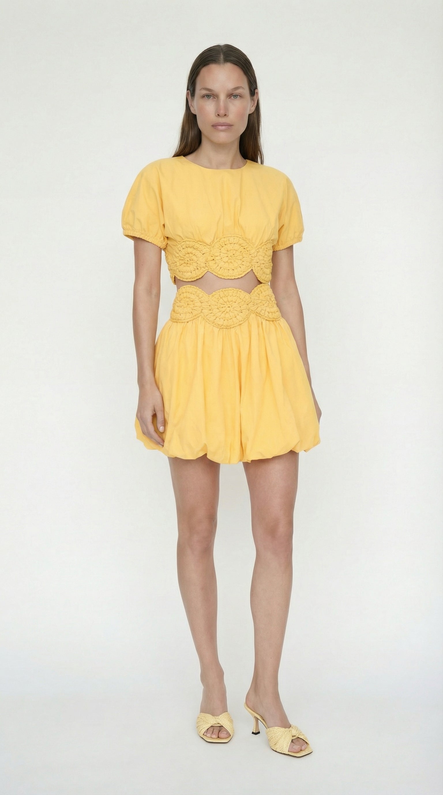 Detailed view of the hand-crocheted elexiay floral hem on the yellow Amara top, highlighting traditional Nigerian artisanal craftsmanship.