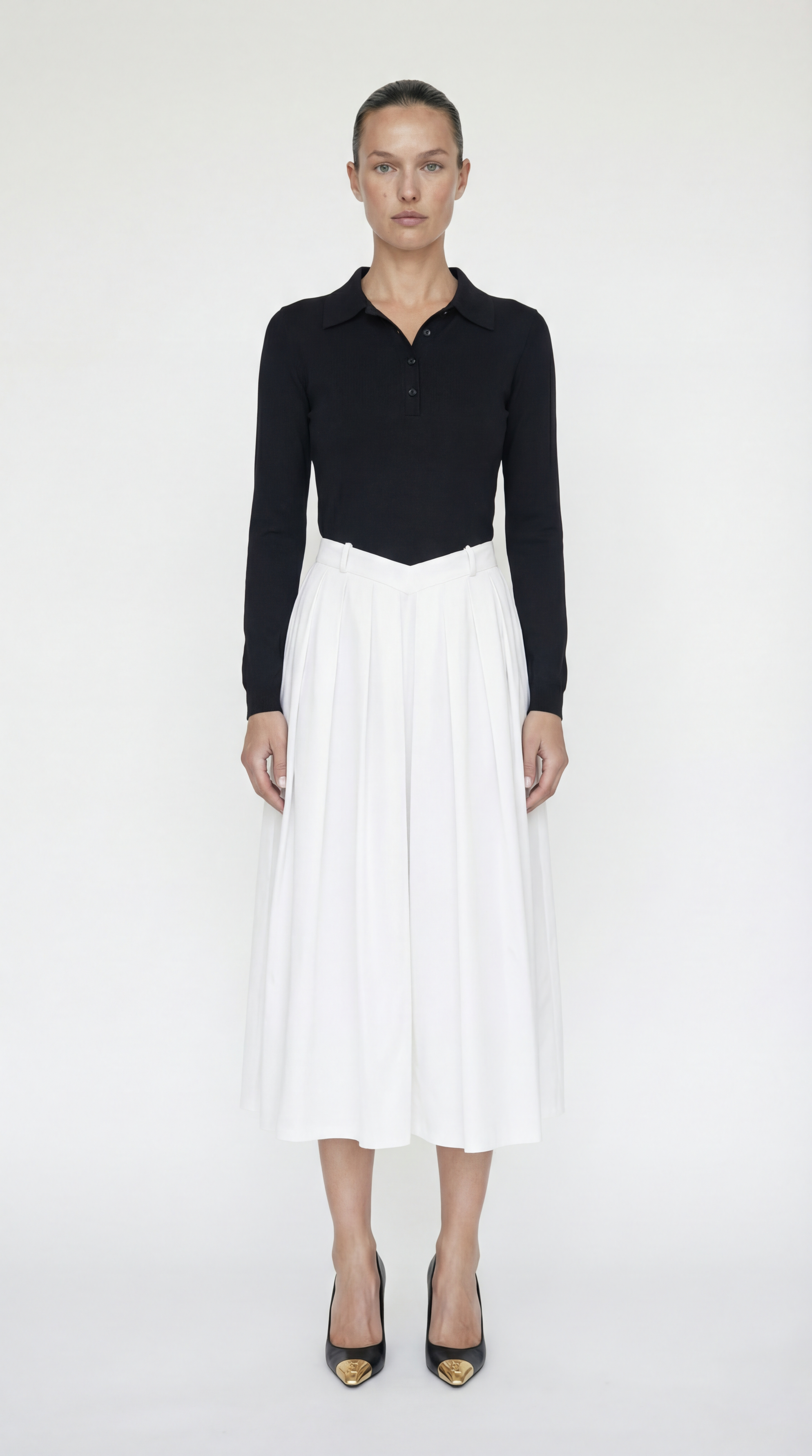 Front view of the Elexiay Sonia Dress featuring a black knit polo bodice and a high-contrast white pleated midi skirt