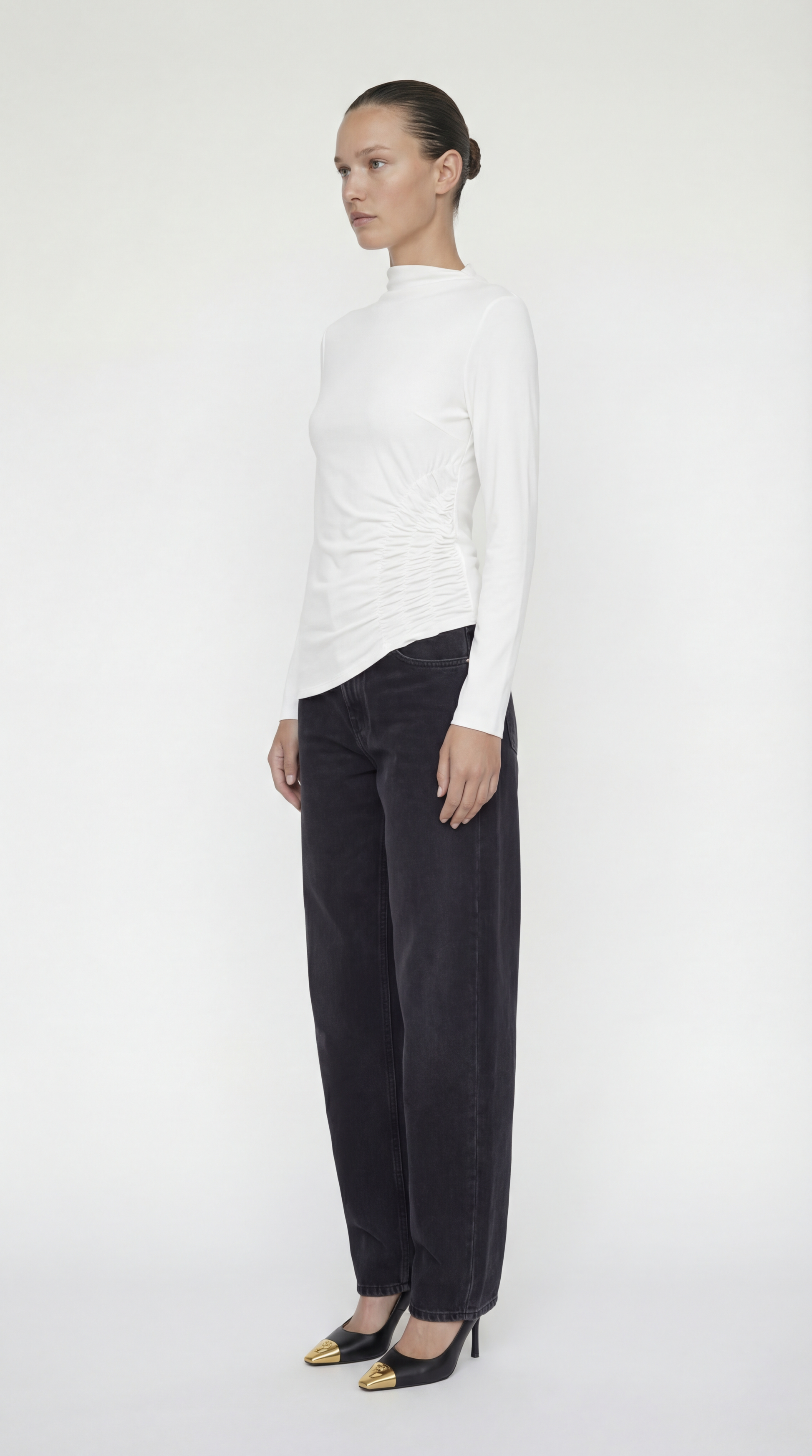 Side view of the Toni Shirt highlighting the flattering ruched silhouette and long sleeve fit