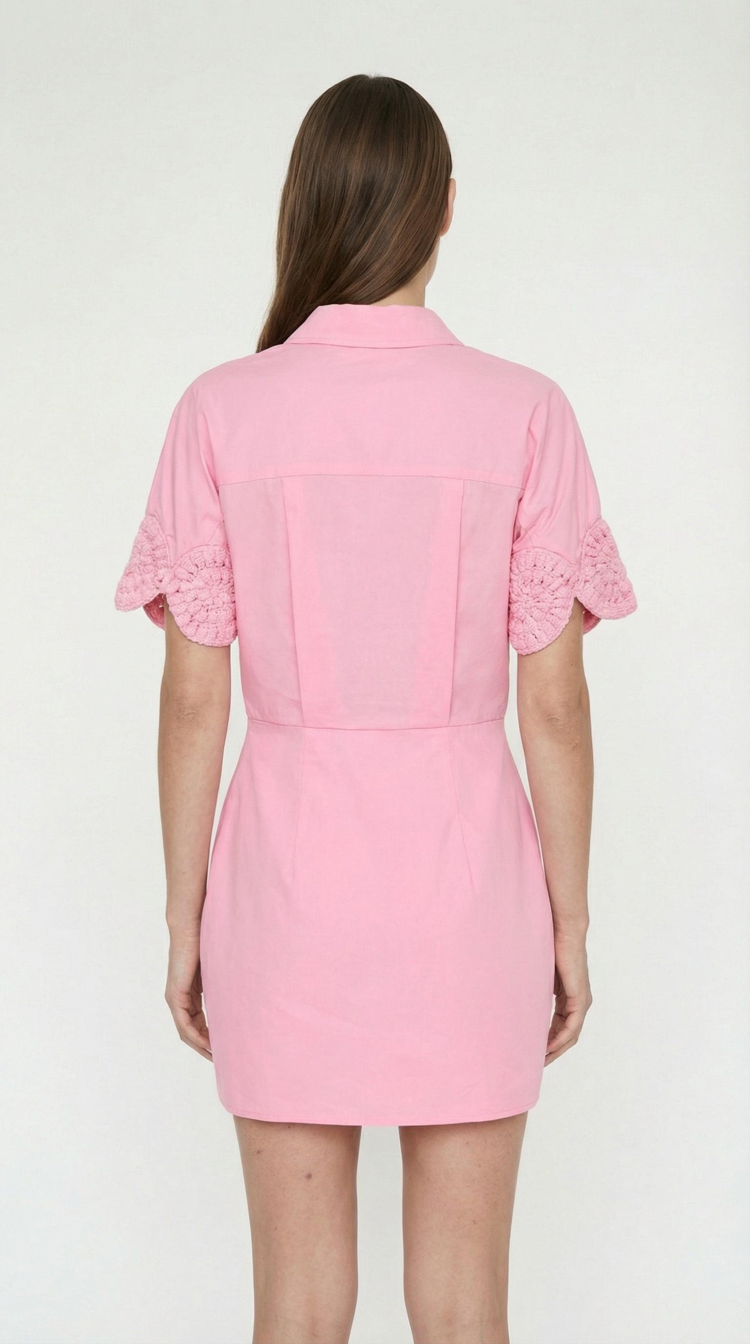 Elexiay Ebube pink mini dress styled with woven sandals and a sun hat for a luxury tropical resort vacation outfit.