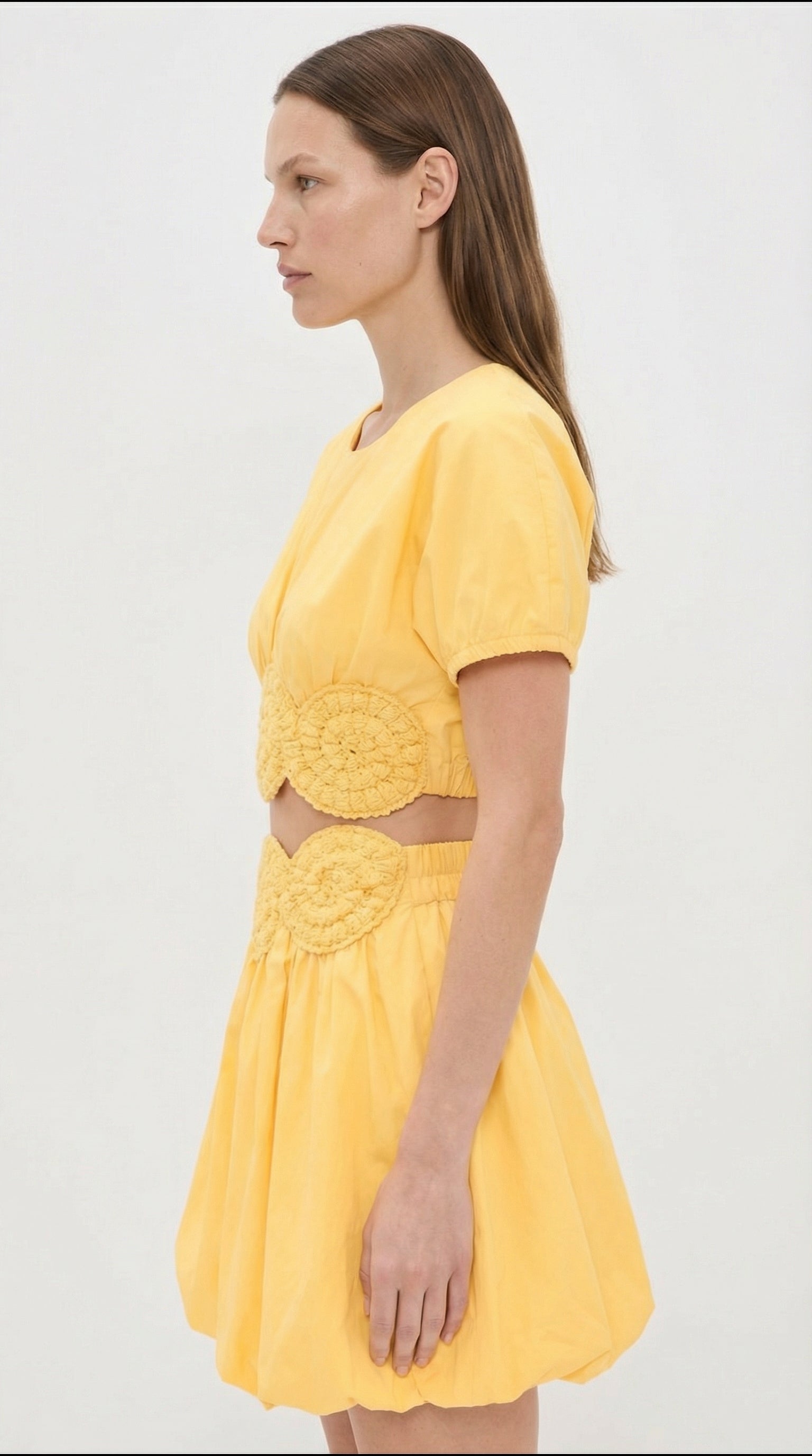Amara elexiay yellow cotton top styled for luxury resort wear, featuring high-quality poplin fabric and unique cutout crochet detailing.