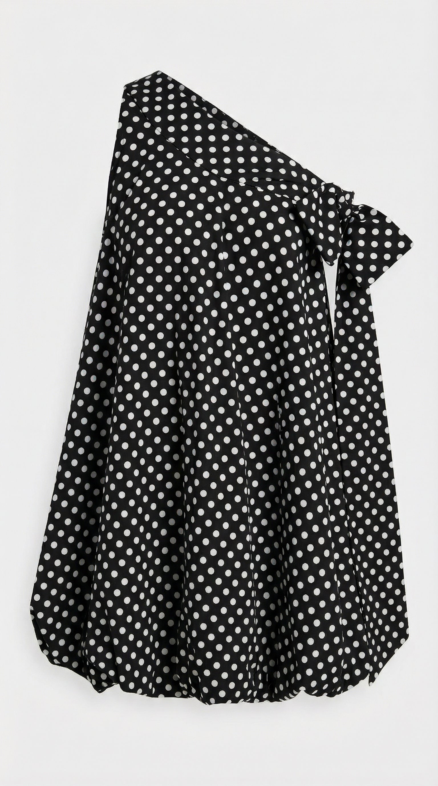 1950s-inspired modern polka dot mini dress with a contemporary bubble skirt and statement bow accents.
