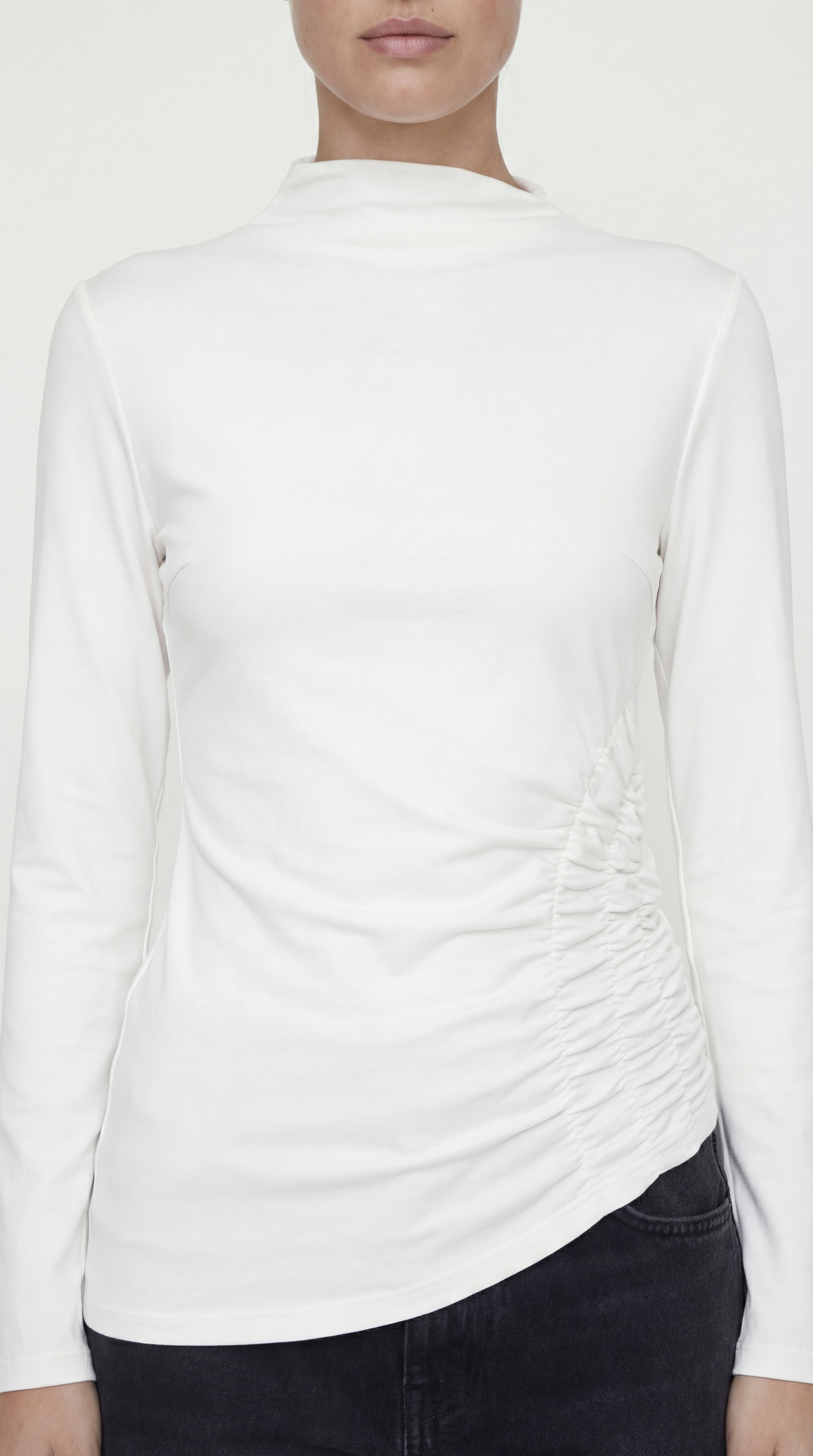 Detailed close-up of the super-stretch jersey fabric and side ruching on the Toni Shirt in ivory.